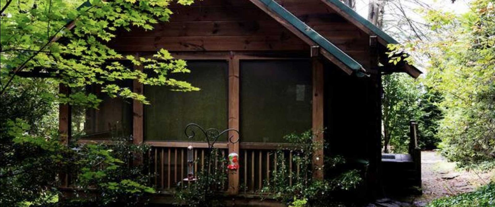 Key Falls Cabin, a wooden cabin with a screened porch in the trees