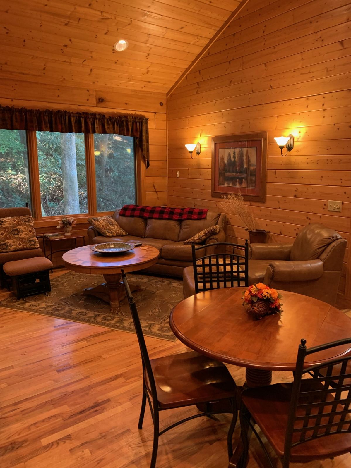 Inside the cabin, wood panelled walls and a dining table