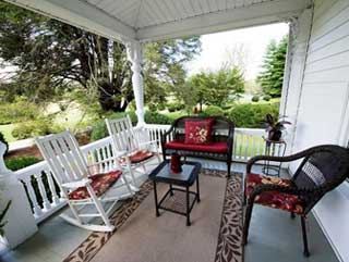 The front porch with rocking chairs overlooking the grounds