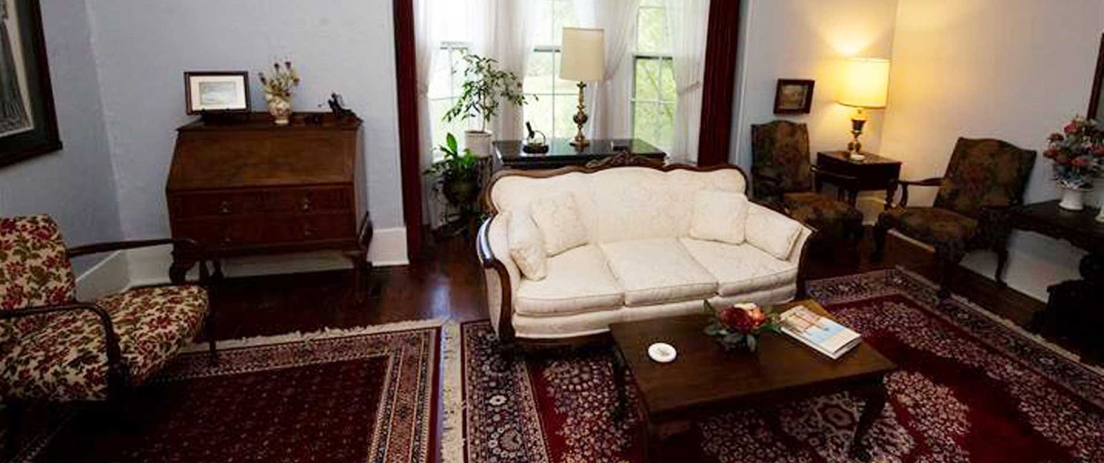 The inn parlor with sofas and a patterned rug